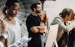 People working on set in a film studio.