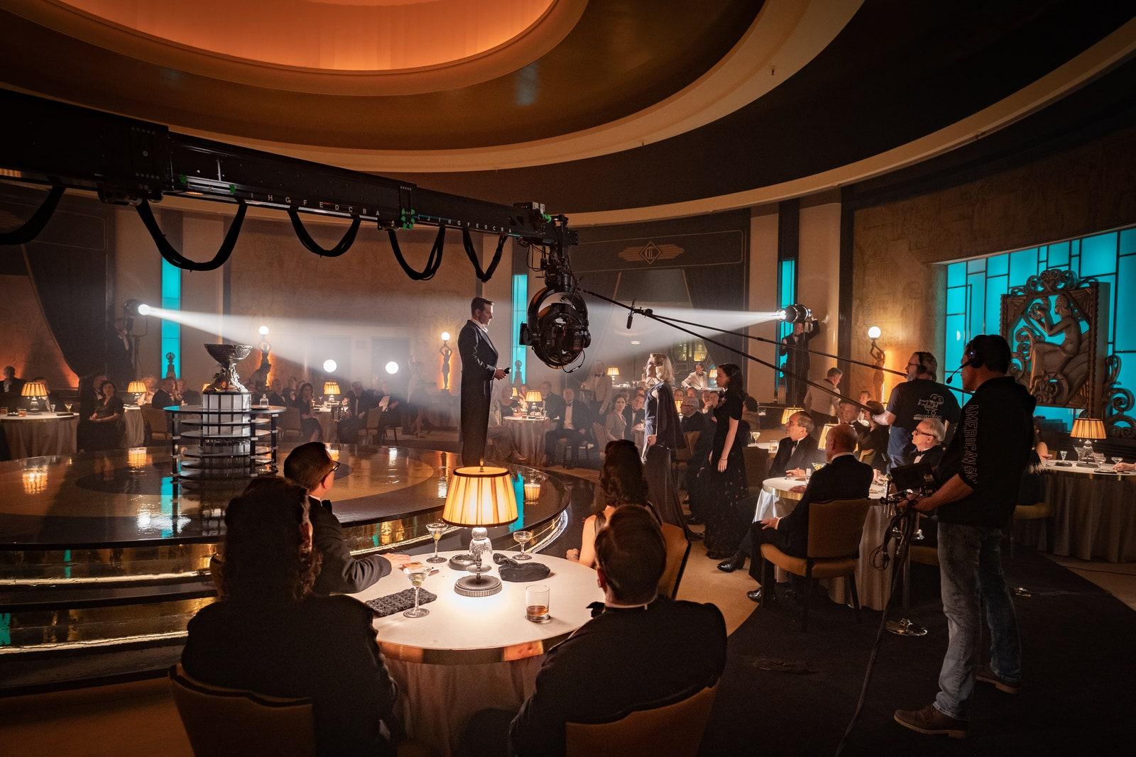 Image may contain Indoors Interior Design Human Person Lighting Stage Crowd Room Restaurant and Pub