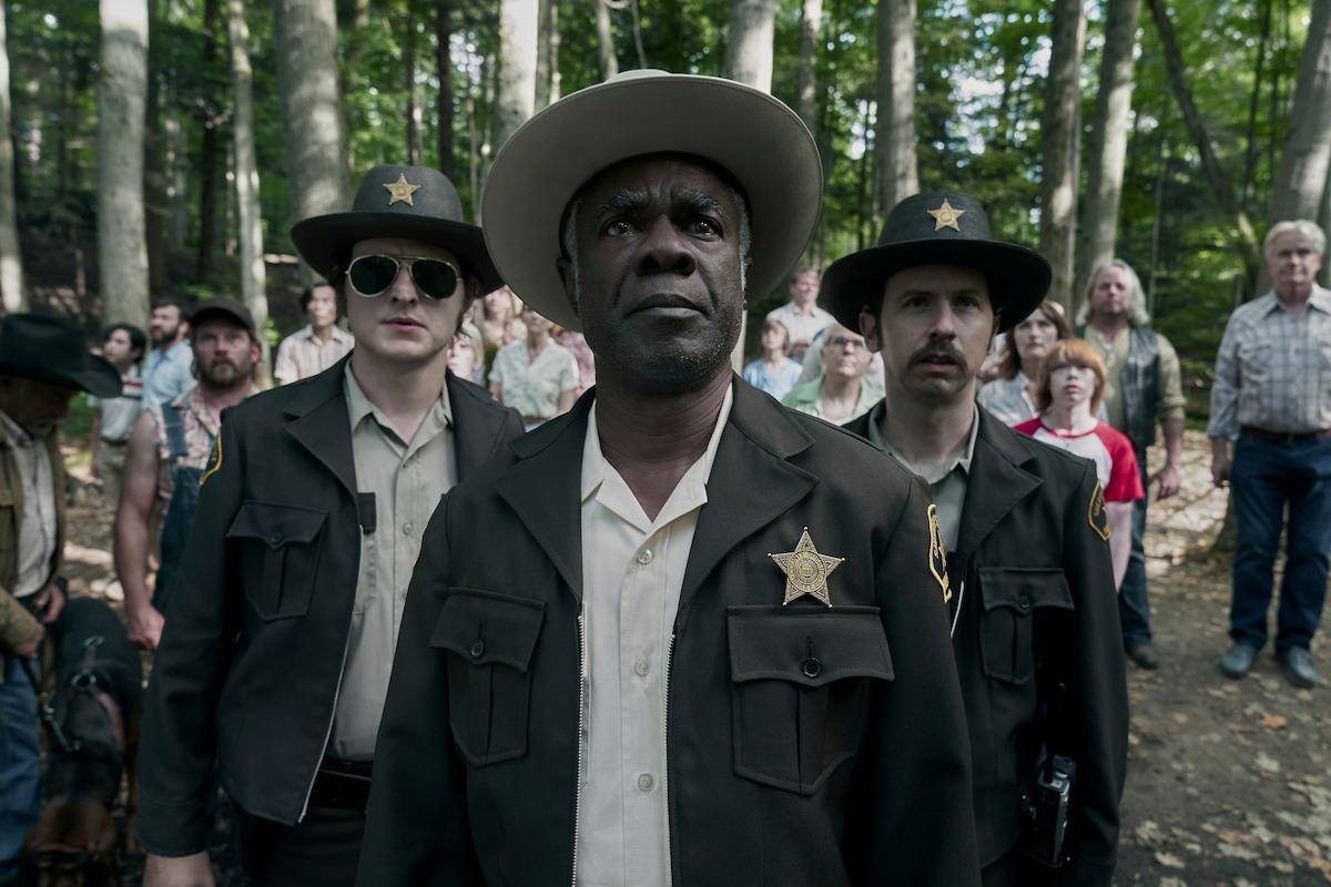 Glynn Turman inspects the scene as Sheriff Craven.
