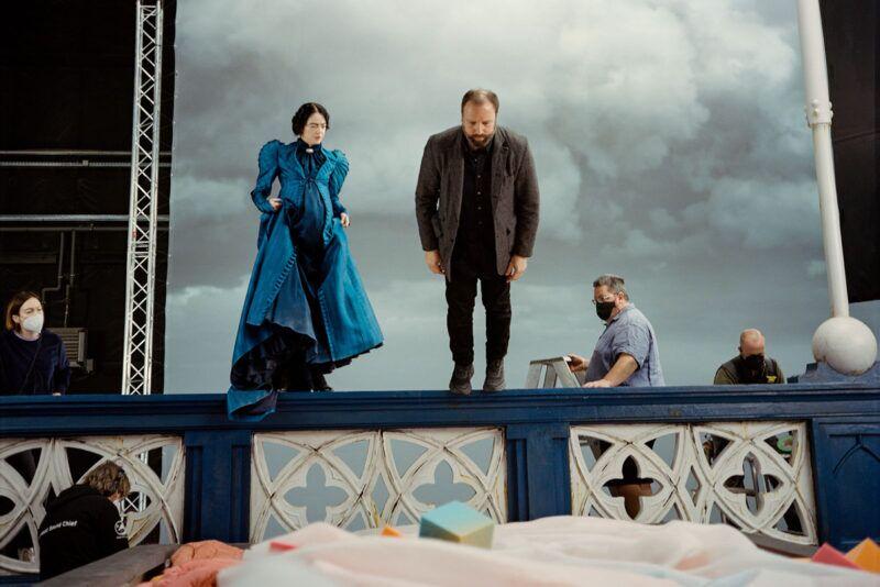 Director Yorgos Lanthimos demonstrates a fall for Emma Stone on the set of Poor Things. Image @ Searchlight Pictures