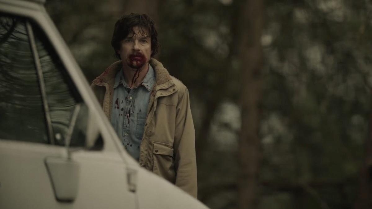 A bloodied Terry maitland near a white van