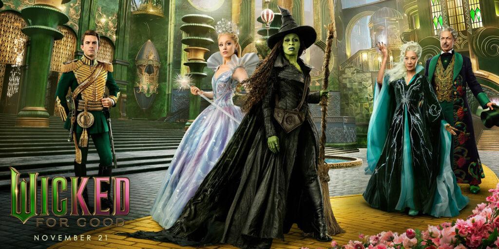 Five characters in elaborate costumes stand in an ornate, green-lit palace. The central figure is dressed in black with green skin. Others wear formal or fantasy attire, including a crown and capes—earning top marks for theatrical flair. Wicked appears below.