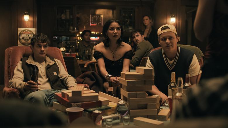 Bear, Sarah, and Ian look concerned at a party in Obsession