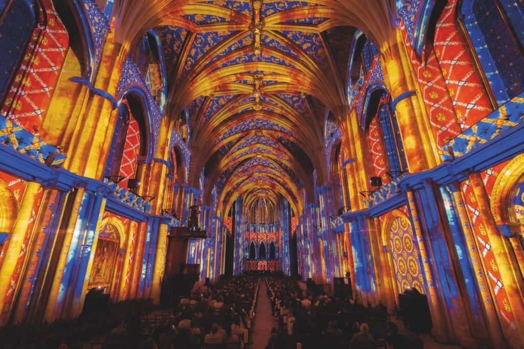 Yellow and blue projection on the roof of a cathedral